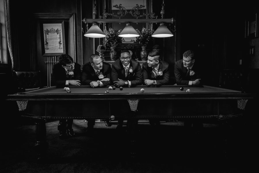 Groom with groomsmen on pool table