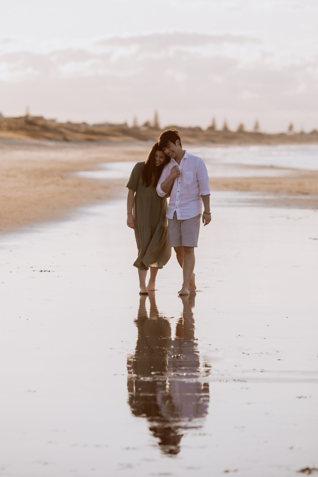 couple in linen colours at golden hour on beach