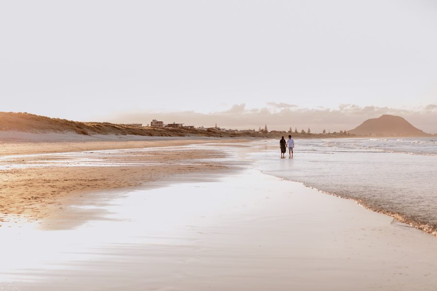 Mount Manganui engagement shoot walking in golden light