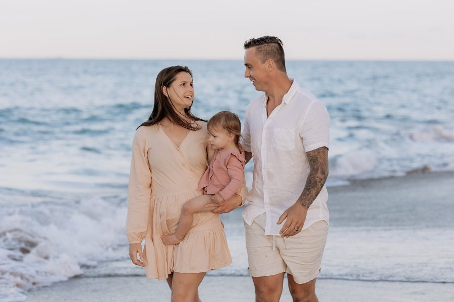 Tauranga family walking on beach at golden hour for family photos