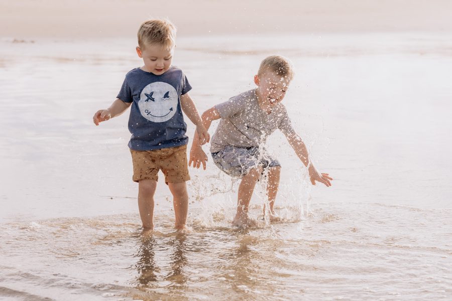 Kids jumping in water on Papamoa Beach