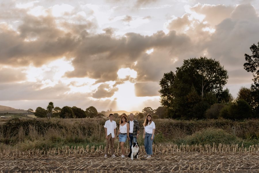 Papamoa family in country setting as sun sets with pet