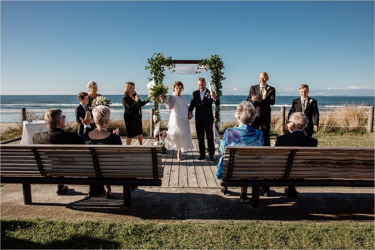 We're married happy bride and groom at Hart Street Beach wedding