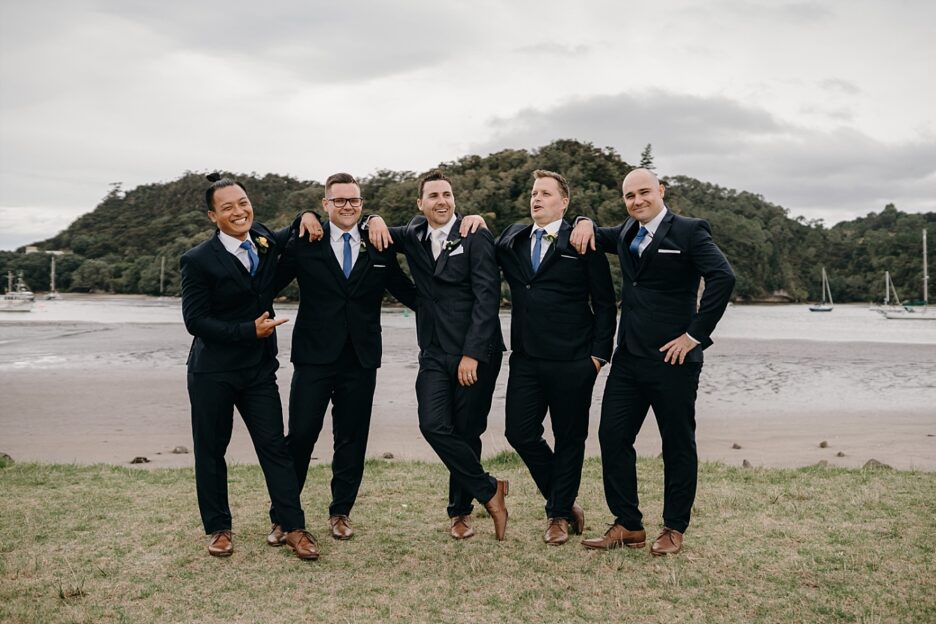 Groom with boys image opposite Cooks Beach