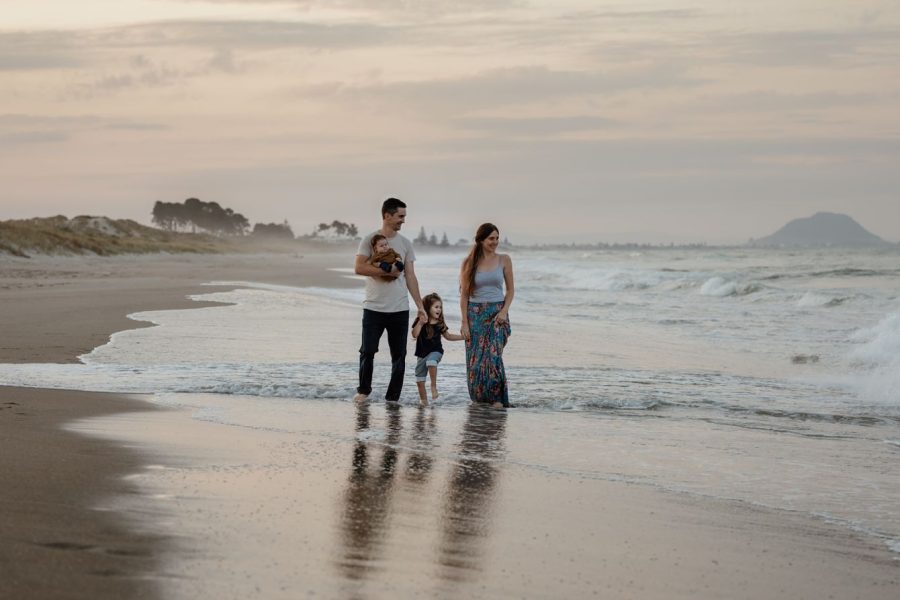 Papamoa family walking on the beach photo