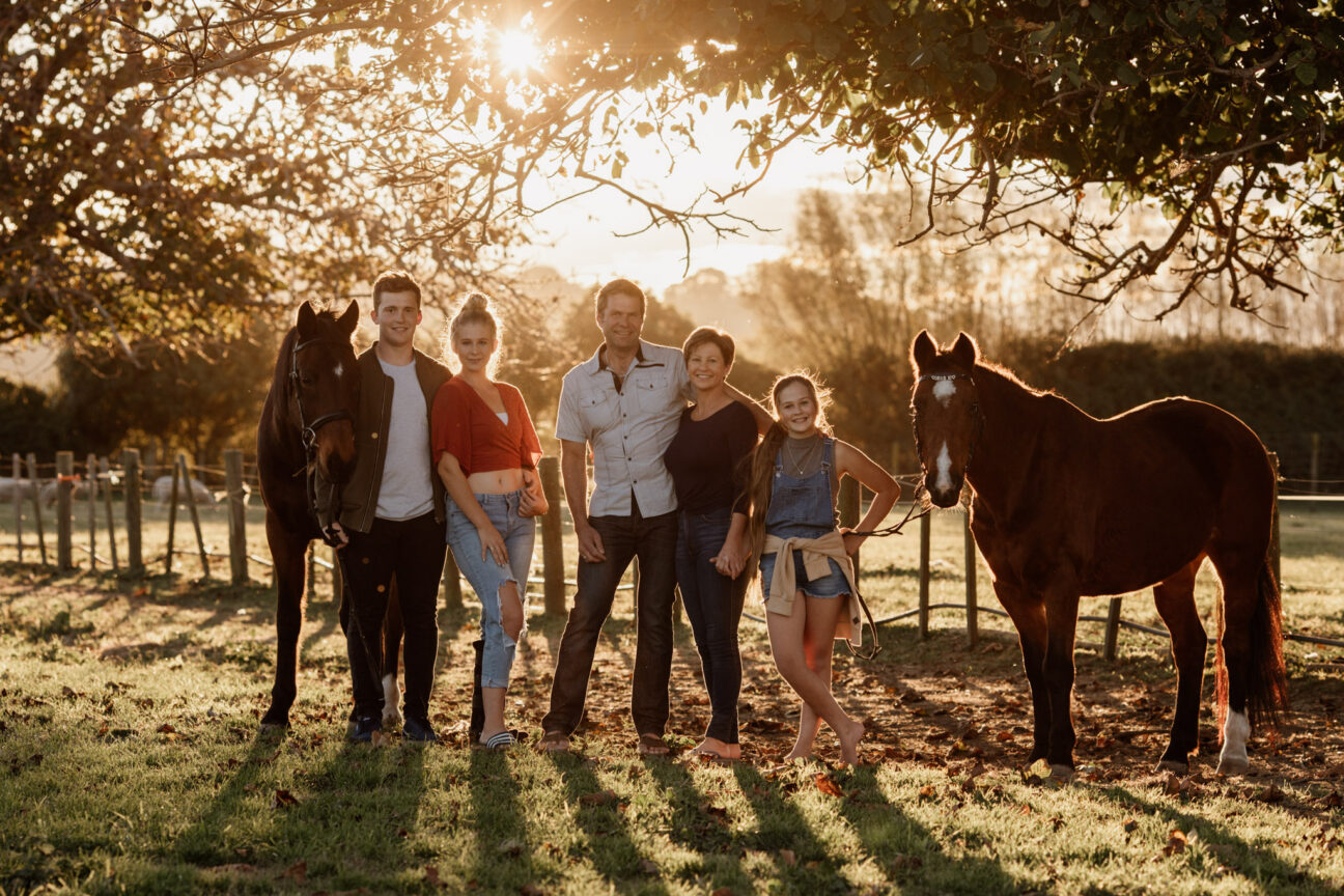 Napier family photo with horses at sunset