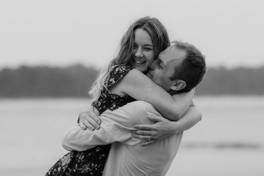 cuddling laughing couple during engagement