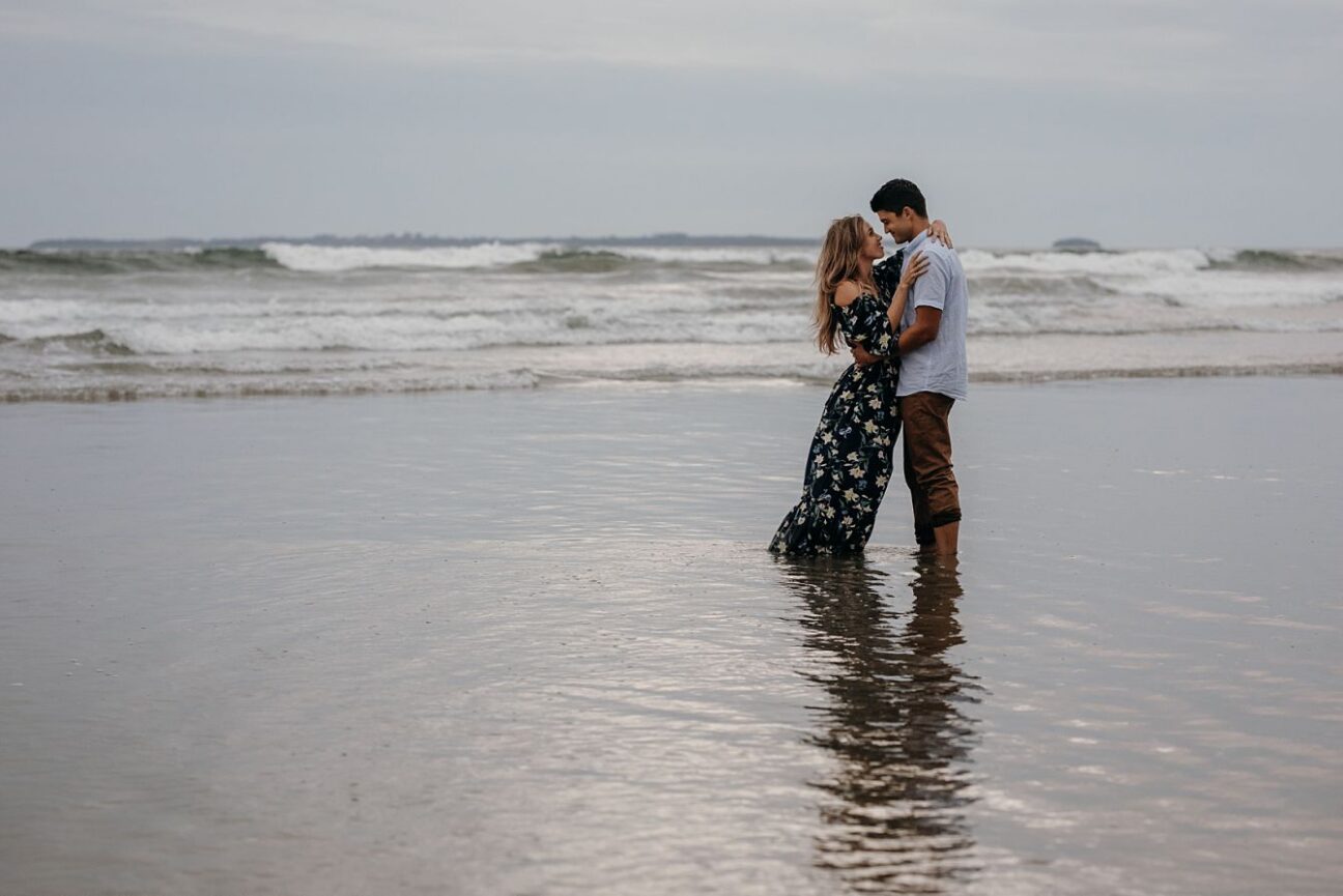 romantic moment in water during couple shoot at Papamoa beach
