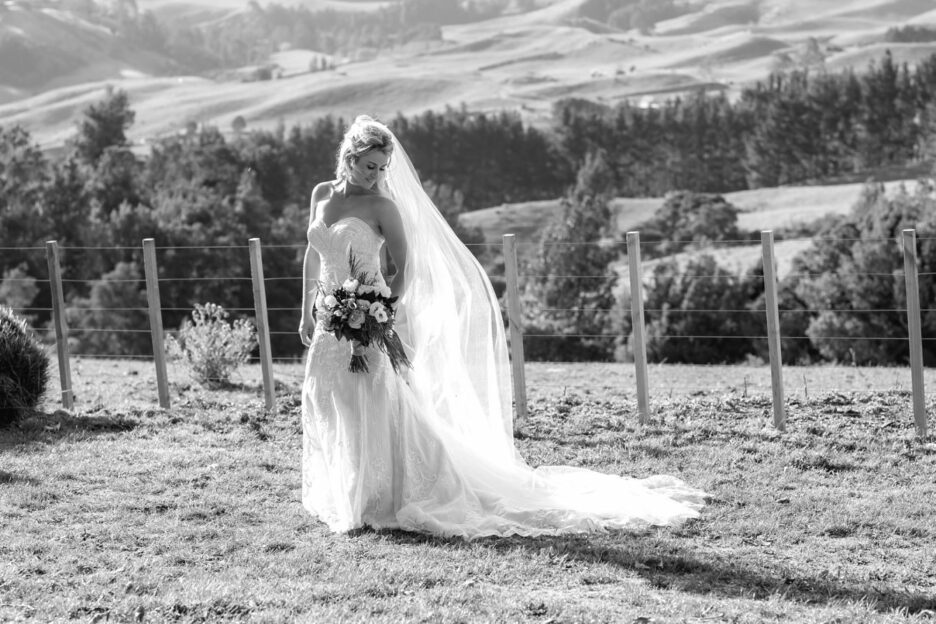 Bride looking down at veil