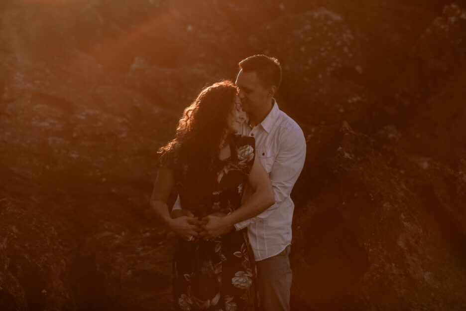 golden moment with couple on beach with sunsetting