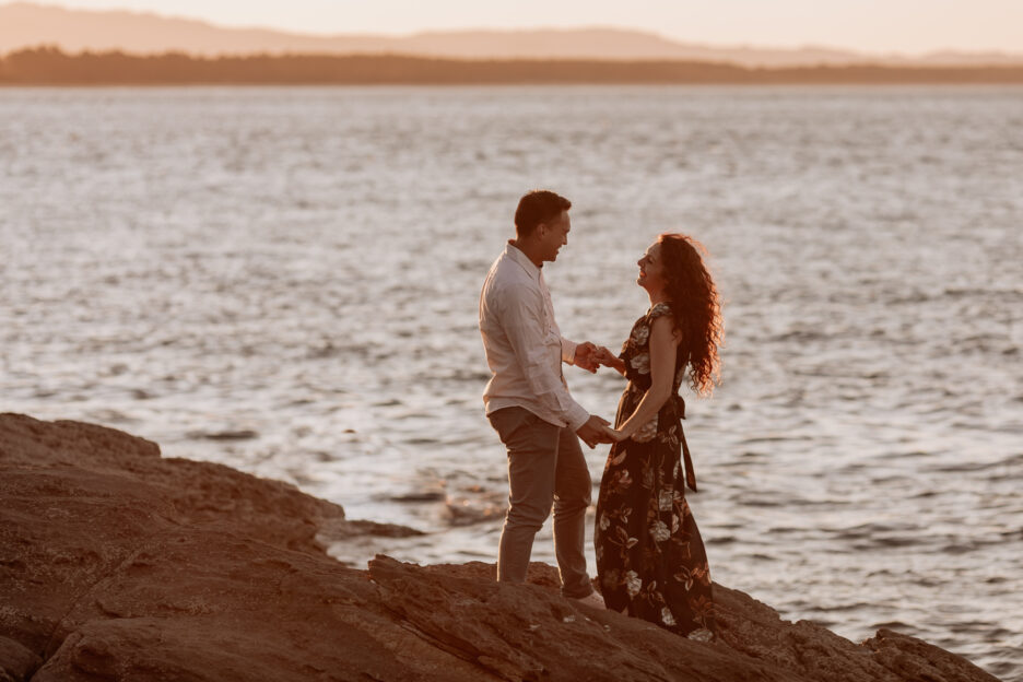 Couple dancing on rocks at Mount Maunganui