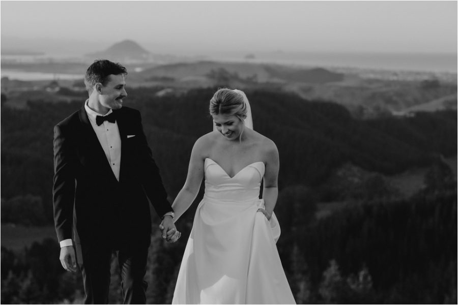 Moody vibe photo country side photo with bridal couple walking on hills