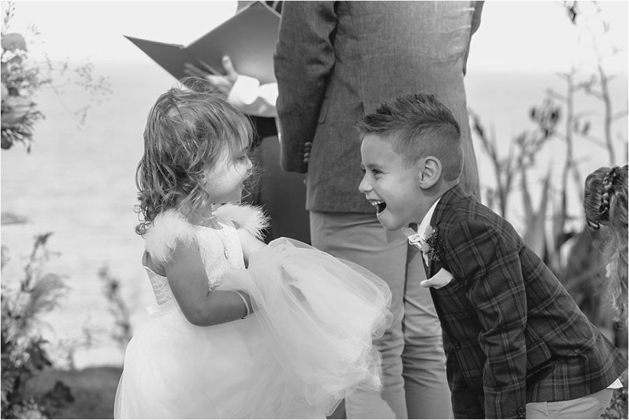 Page boy laughing with flower girl