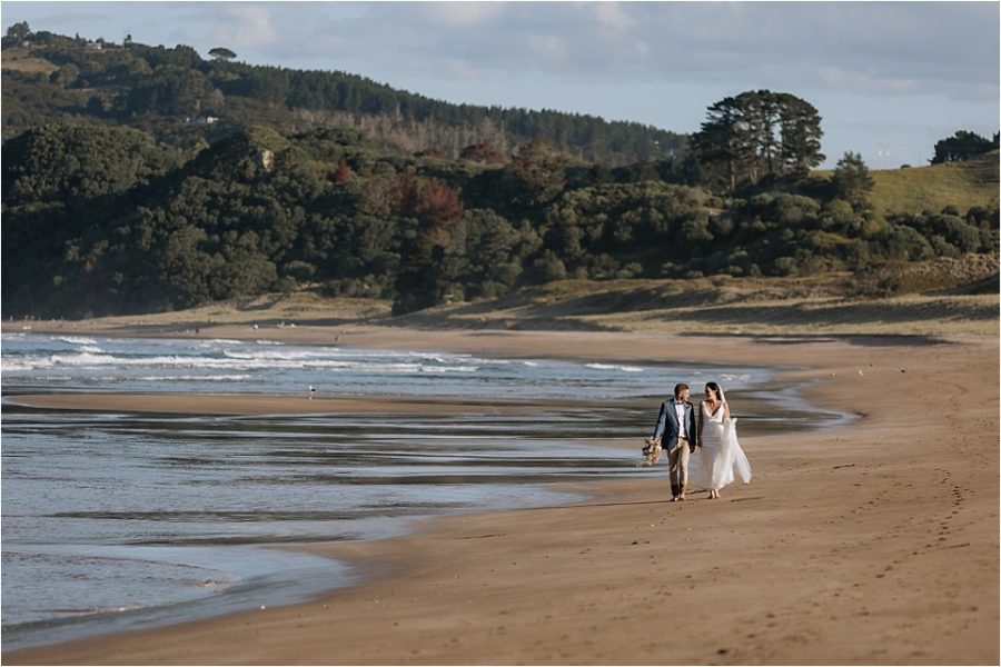 Orua Beach house Bride and Groom walking