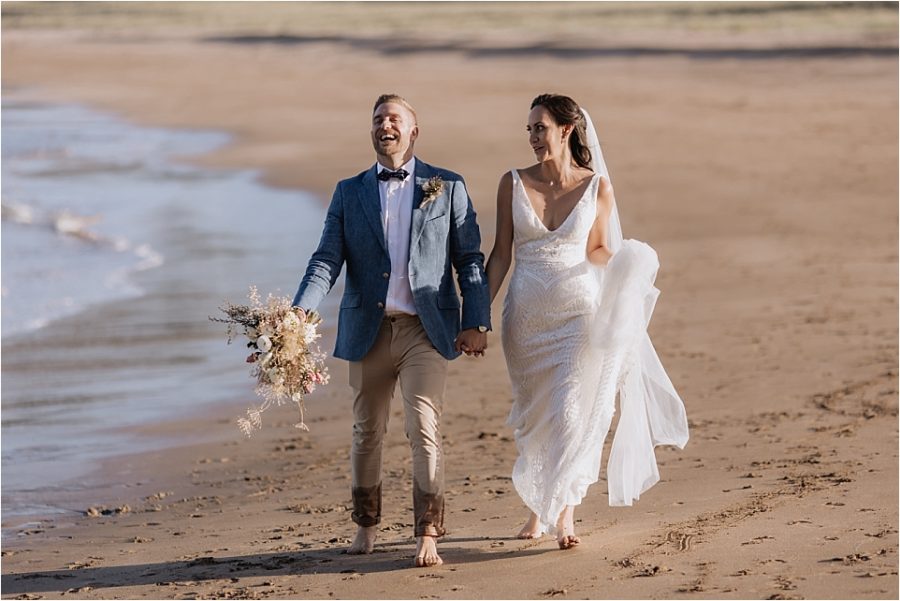 Laughing groom on Hot Water beach New Zealand