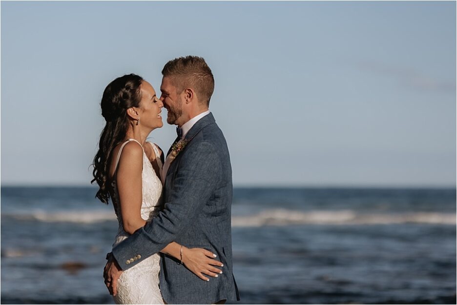 moments between Bride and groom on rocks at Hot Water beach