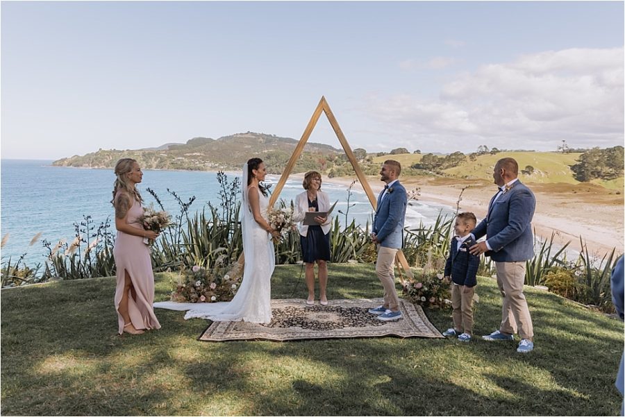 Wedding ceremony on cliff face at Orua beach house