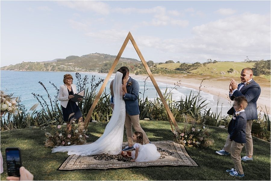 Wedding ceremony kiss over looking Hot Water beach