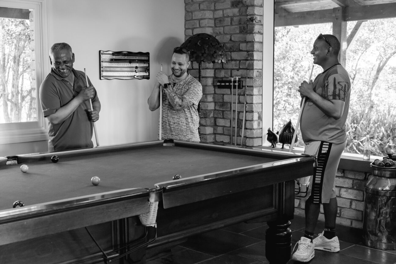 Groomsmen playing pool