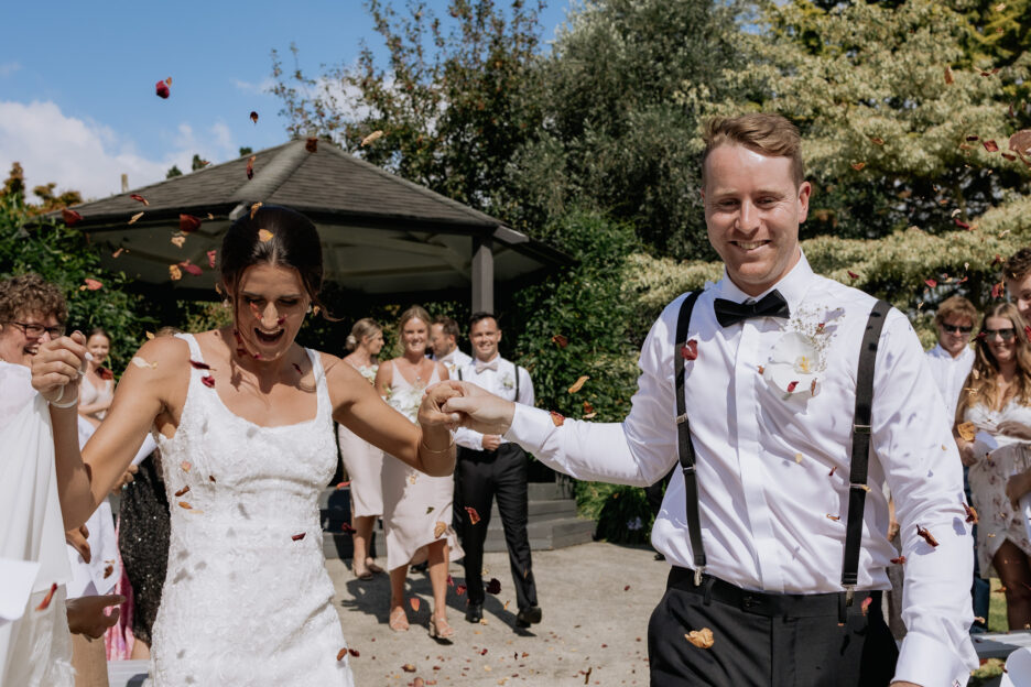 Happy aisle walk with petals being thrown