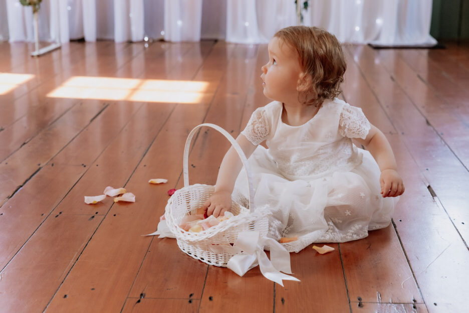 Flower girl with hand in basket of petals