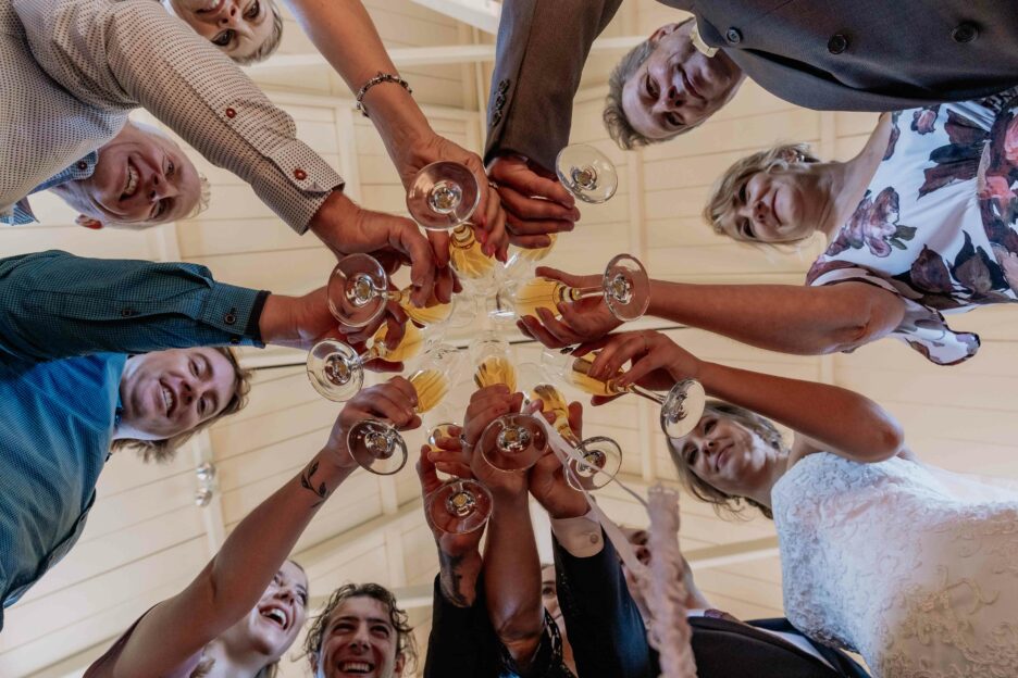 Drink congratulation glasses with hands of guests