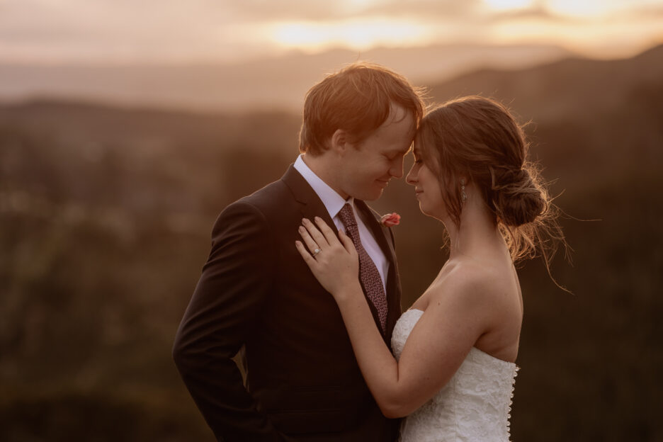Cuddling bridal couple in golden light