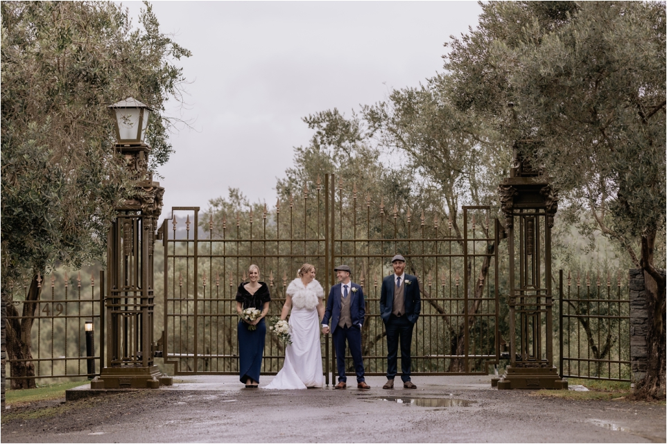 Bracu gates with wedding party on wet day