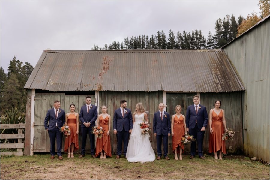 Bridal party at Makoura Lodge against green shed
