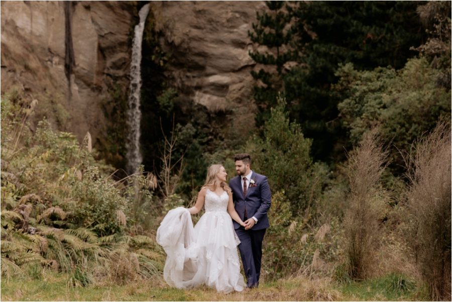 Wedding photos at Makoura Lodge Palmerston North in front of waterfall