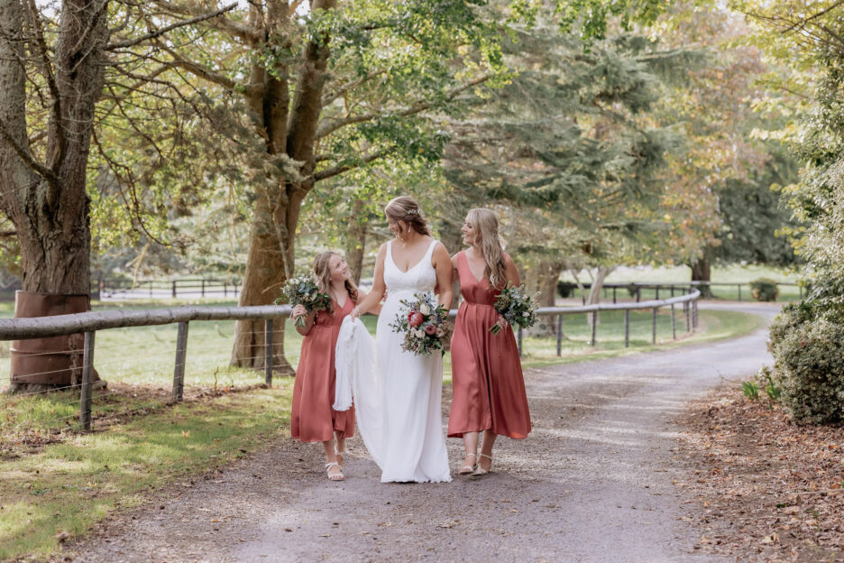 Happy bridal party walking in driveway having fun