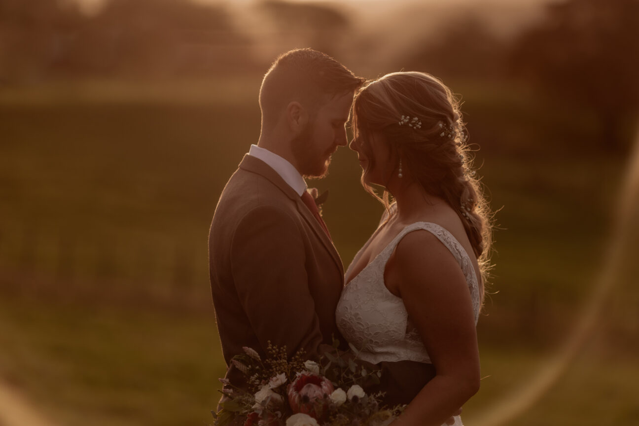 golden hour photos of farm wedding bridal couple