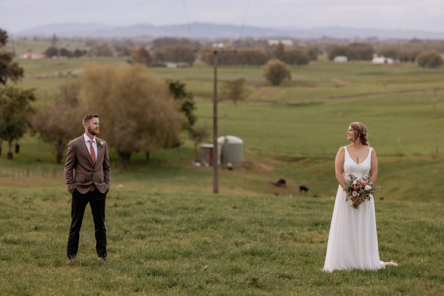 bride and groom looking at each other with power lines between them