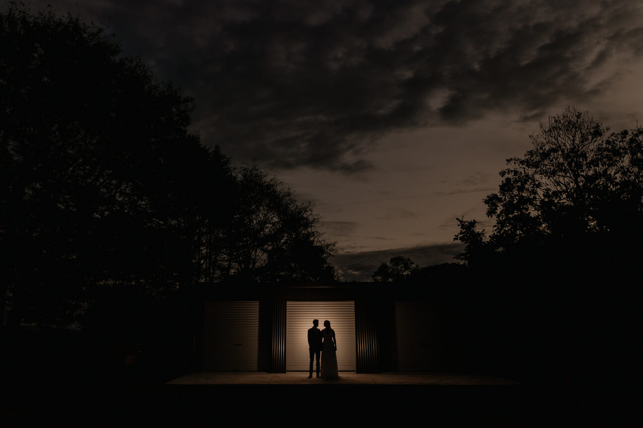 wedding photos in the evening with farm shed door lit up