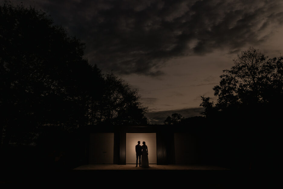 wedding photos in the evening with farm shed door lit up