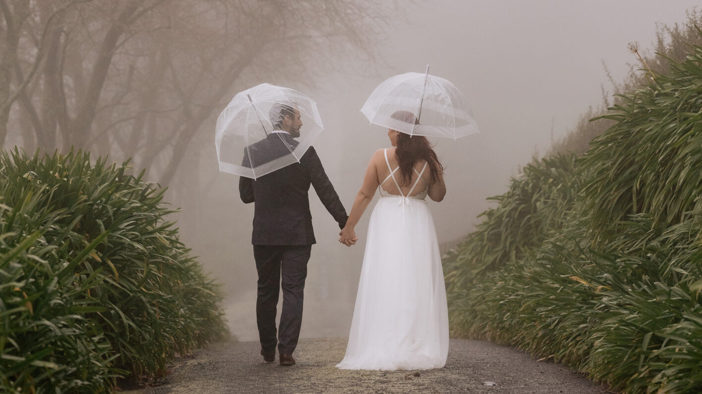 walking in the rain wedding couple