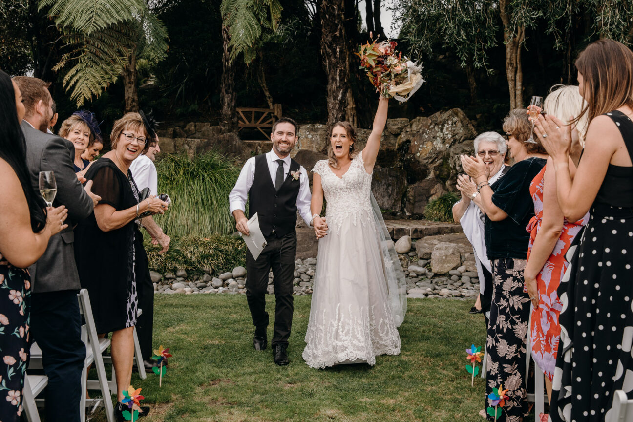 Happy couple walking down aisle celebrating just married!