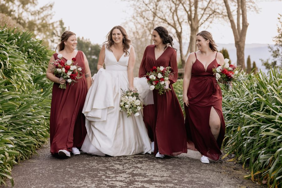 Laughing bridesmaids in red dresses