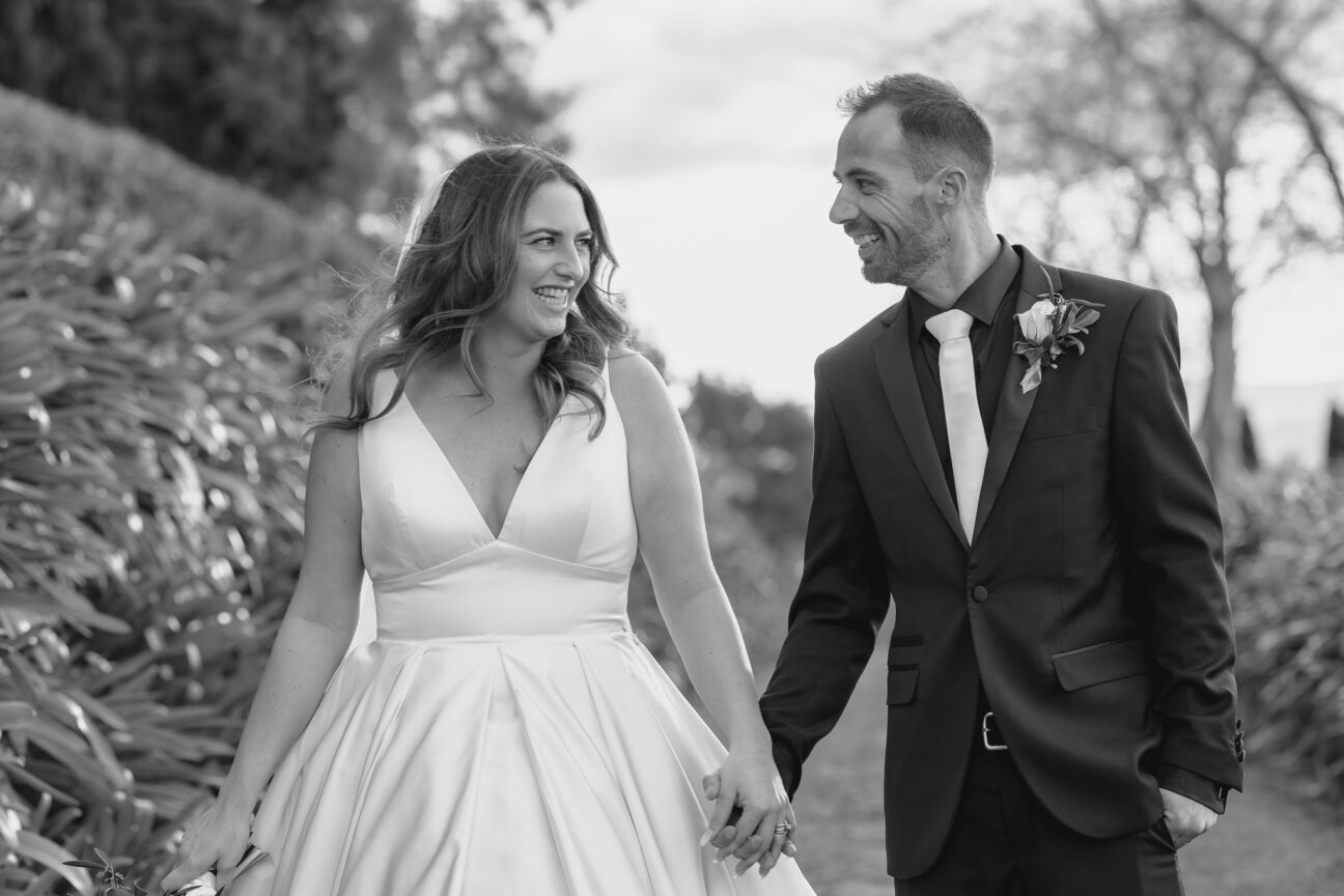 bride and groom looking at each other smiling