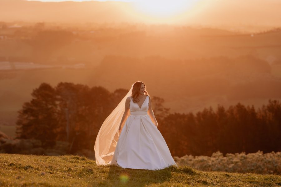bride in astra bridal dress upon sunset