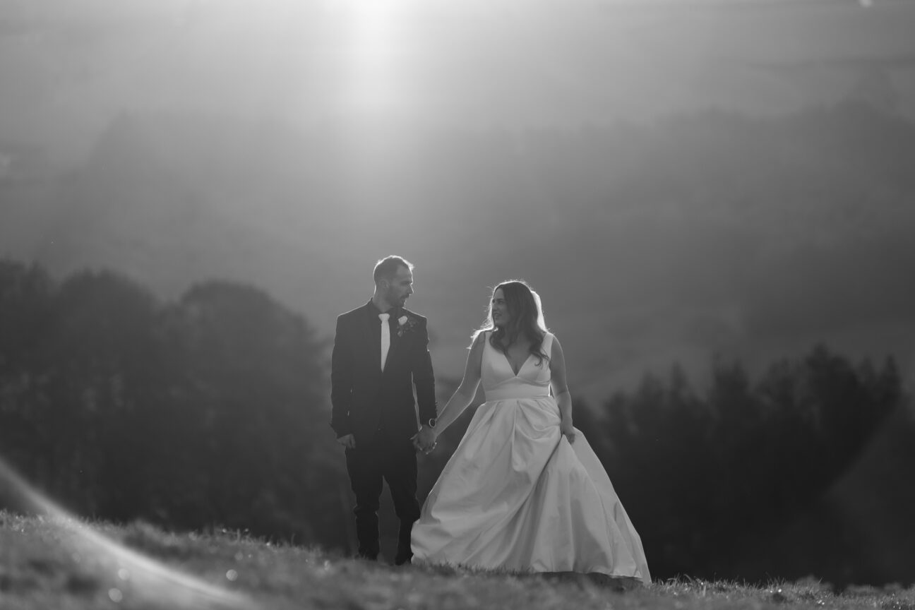 bride and groom looking at each other holding hands