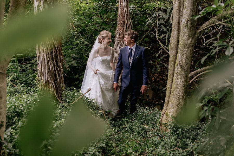 walking in the New Zealand bush in greenery back yard wedding