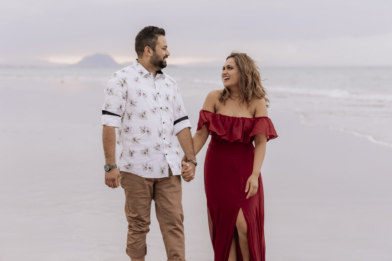 couple laughing on beach photoshoot
