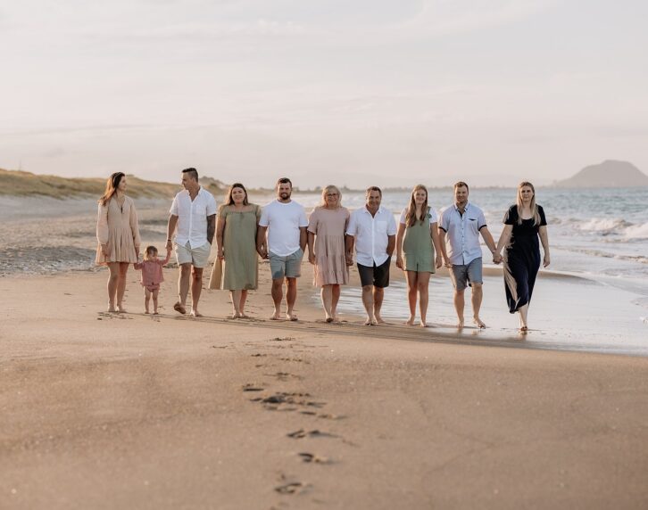 Family photo session walking on Papamoa beach in soft light