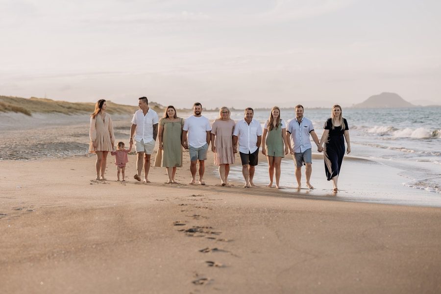 Family photo session walking on Papamoa beach in soft light