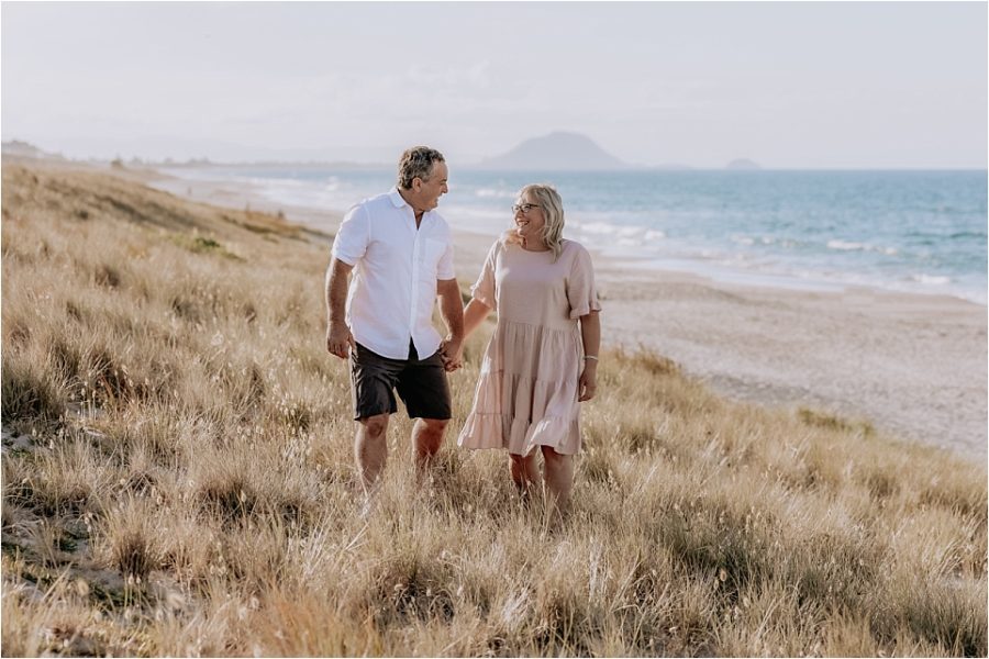 Relaxed walking during photo session on beach in dunes