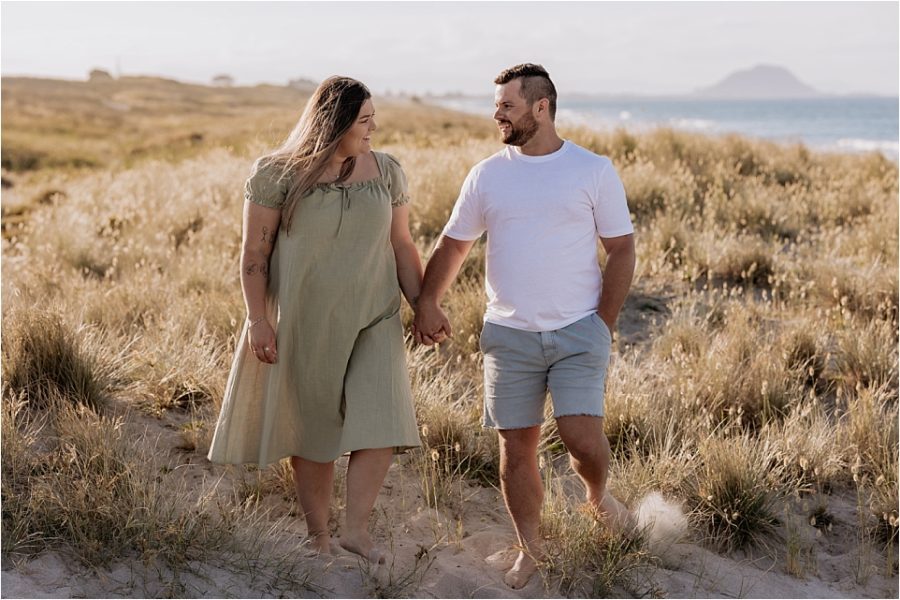 Couple walking on Mount Maunganui dunes