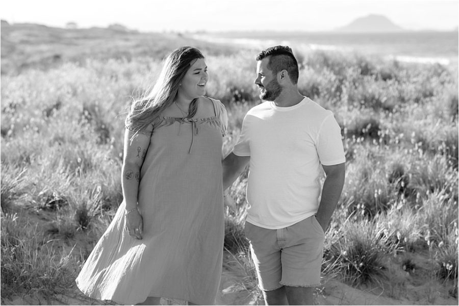 Natural candid photos of couple walking on Papamoa Beach