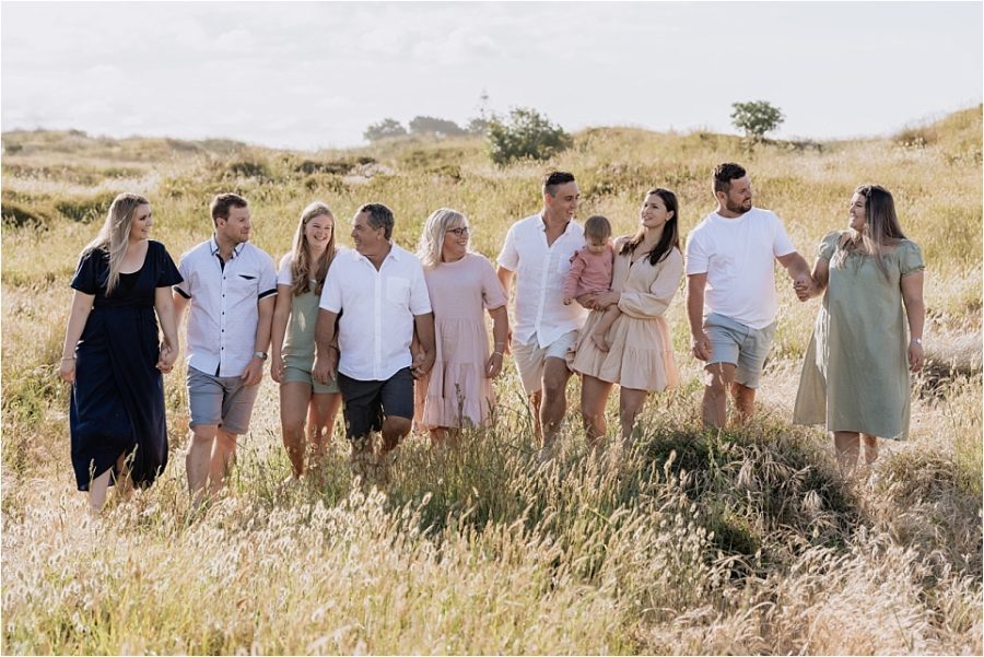 Family walking in the sand dunes on Papamoa Beach