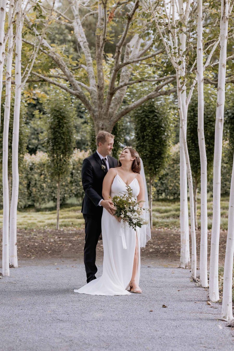 Happy bride and Groom Tree church pathway